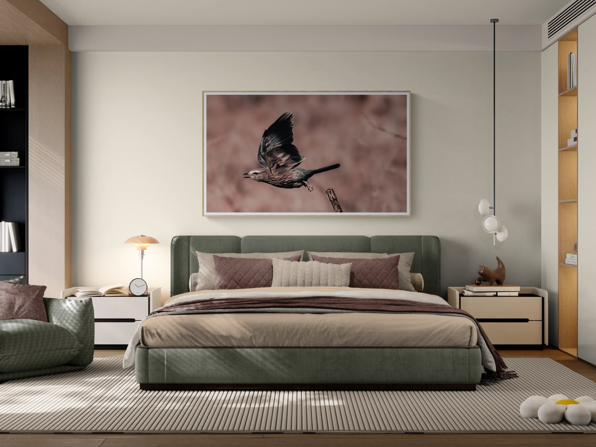 A modern bedroom featuring a large framed wall fine art print of a bird in flight, hung above a green upholstered bed.