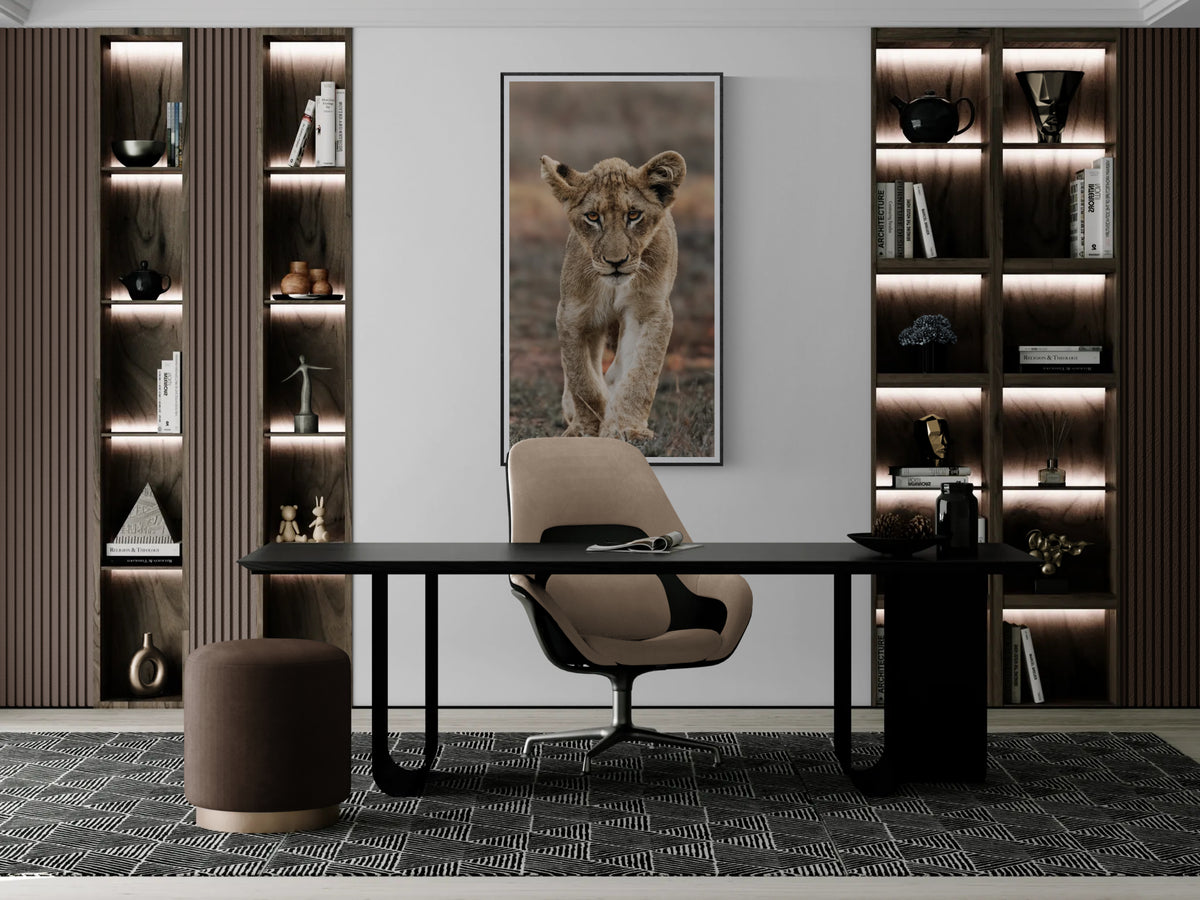 Coming of Age fine art lion cub print framed and displayed behind a modern home office desk.